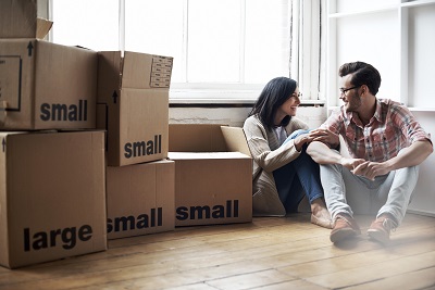couple surrounded by moving boxes