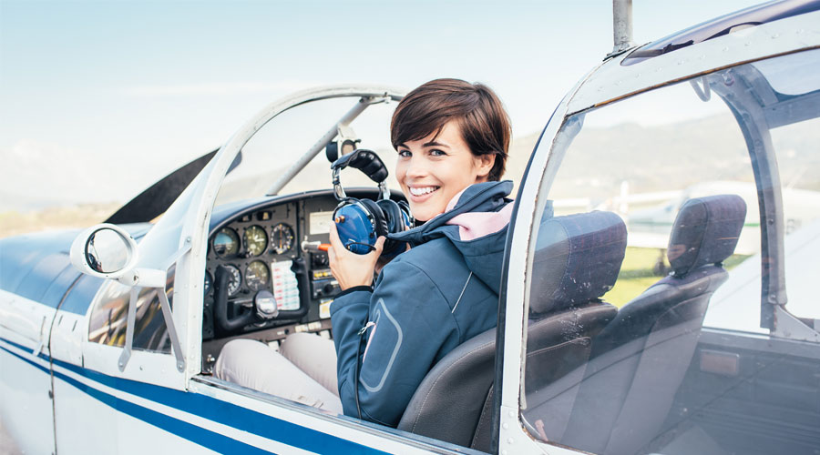 female pilot inside cockpit of aircraft