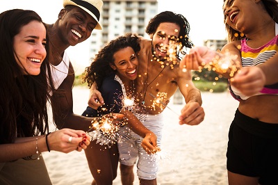 friends on beach with sparklers