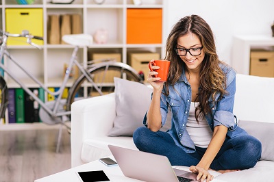 woman sitting on floor with laptop