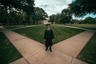 college graduate on campus; photo by Jonathan Daniels on Unsplash